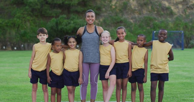 Group of Happy Children and Coach at Outdoor Soccer Field - Download Free Stock Images Pikwizard.com