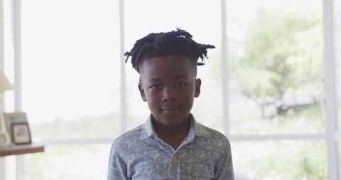 Portrait of Young Boy Standing in Bright Living Room - Download Free Stock Images Pikwizard.com