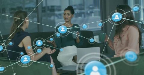 Women leading digital networking discussion in modern office lounge with virtual connection overlay