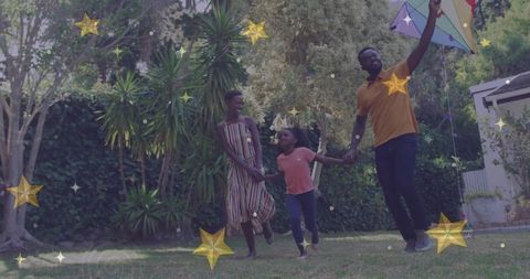 Happy Family Playing with Kite in Artistic Garden Area