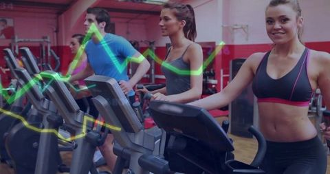 Smiling woman training on elliptical with group cardio workout and analytics overlay