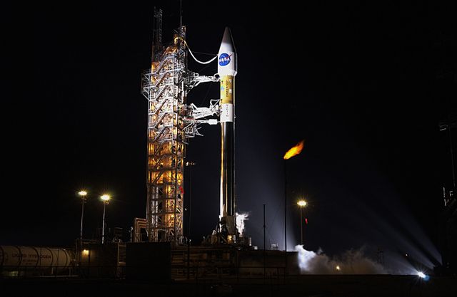 Night view of mobile service tower revealing Atlas IIA rocket with TDRS-J satellite at Launch Complex 36-A, Cape Canaveral. Suitable for space exploration, aerospace engineering, satellite communication updates, and NASA missions. Great for use in educational materials, documentaries, articles, and websites about advances in space technology.