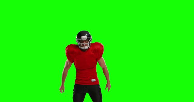 American football player standing in red jersey, black helmet, and uniform on a green screen. Ideal for sports promotions, game advertisements, and athletic training resources.