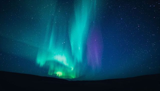 Aurora Borealis Shimmering Over Remote Plain with Starlit Night