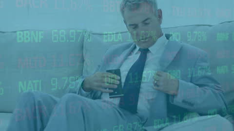 Businessman Analyzing Financial Data on Couch