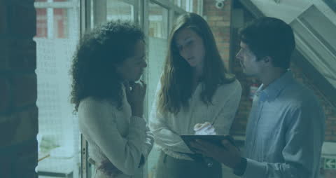 Diverse Business Team Analyzing Data Using Tablet Technology