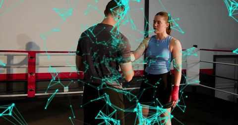 Female Boxer Training with Coach in Boxing Ring Wearing Red Hand Wraps