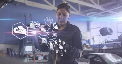 Female mechanic engaging with digital interface in workshop