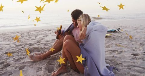 Romantic Couple Snuggling on Beach at Sunset with Stars