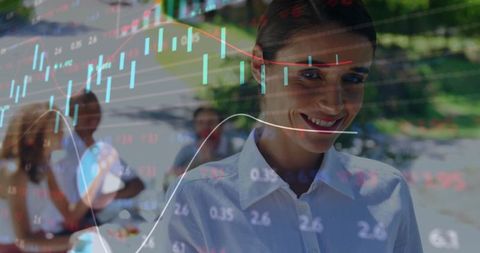 Professional woman analyzing financial data in outdoor team setting