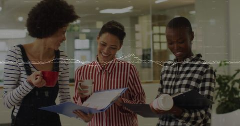Diverse Businesswomen Analyzing Data with Coffee