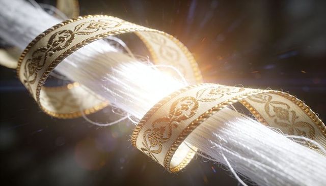 Glowing silk threads wrapping through ornate cream gold ribbon, macro luxury texture