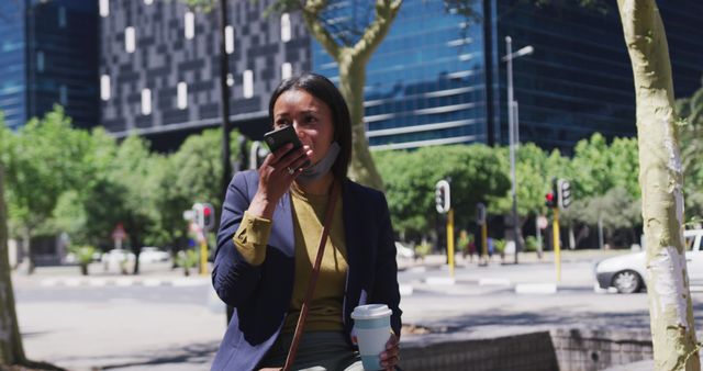 Businesswoman using smartphone and drinking coffee outdoors in urban area - Download Free Stock Images Pikwizard.com