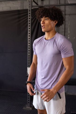 African american athlete in gym with fitness tracker