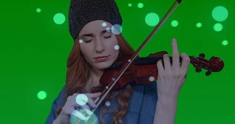 Violinist Playing Music in Green Tenue Studio Setting