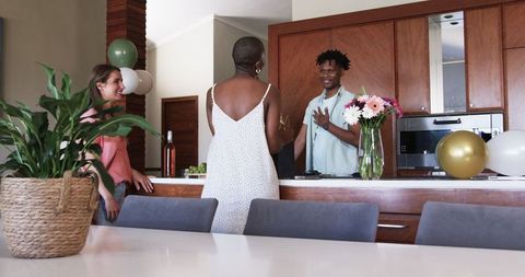 Friends Gather in Modern Kitchen Home Socializing