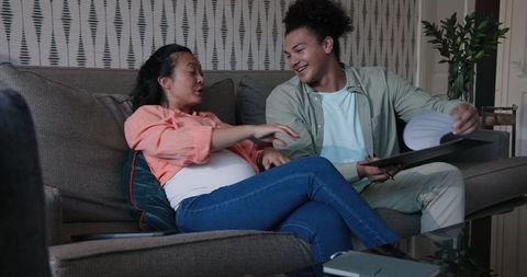Happy couple discussing wedding plans on couch