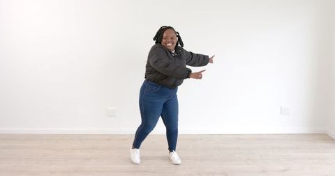 Energetic Woman Dancing Joyfully Indoors in Casual Attire