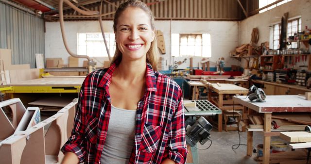 Confident Female Carpenter Smiling in Wood Workshop - Download Free Stock Images Pikwizard.com