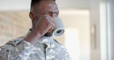 Military Soldier Drinking Coffee in Relaxed Home Environment