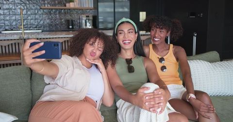 Three Friends Taking Selfie on Sofa in Cozy Modern Living Space
