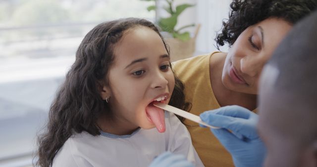 Doctor Checking Young Girl's Throat During Medical Exam - Download Free Stock Images Pikwizard.com