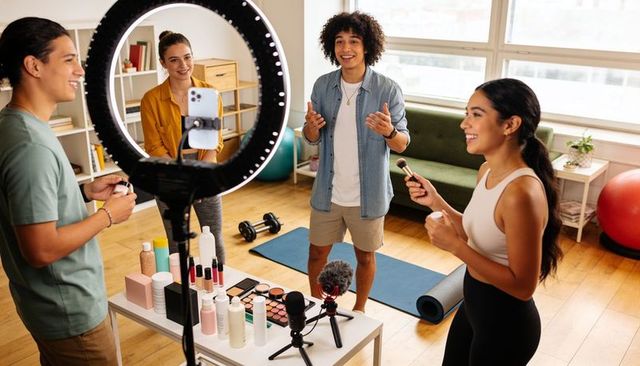 Filming diverse creators doing makeup and fitness demo with ring light and microphones