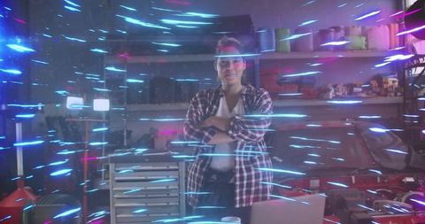Woman Mechanic Standing Confidently in Neon-Lit Garage Workshop with Laptop
