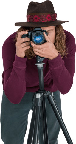 Transparent young photographer at work with camera on tripod