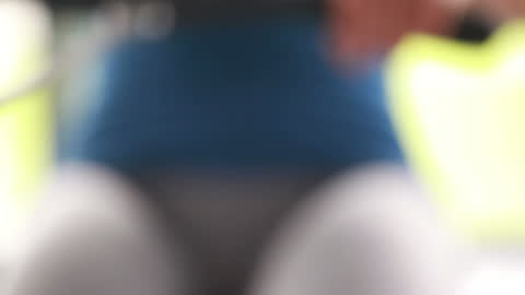 Person Exercising on Rowing Machine in Gym