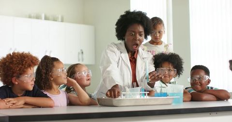 African american stem teacher leading young students in hands-on chemistry experiment