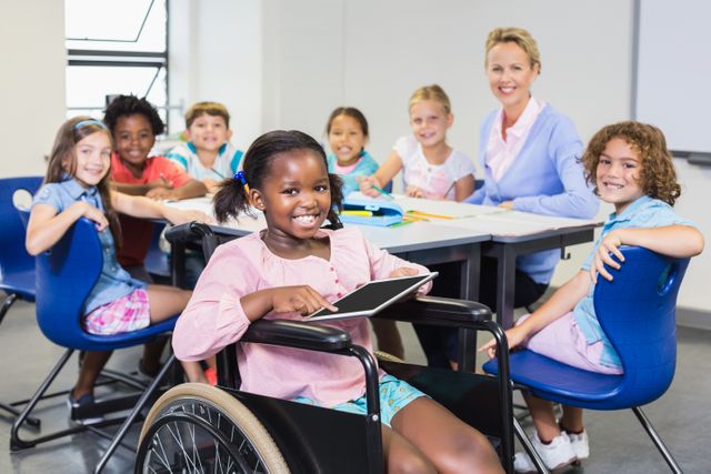 Group of diverse students and a teacher in a classroom setting. One student in a wheelchair holding a tablet, highlighting inclusion and technology in education. Ideal for use in educational materials, diversity and inclusion campaigns, and school-related promotions.