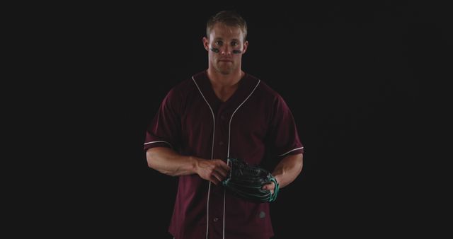 Male Baseball Player Wearing Team Uniform in Black Background - Download Free Stock Images Pikwizard.com