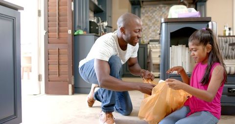 Father and Daughter Cooking Together in Kitchen