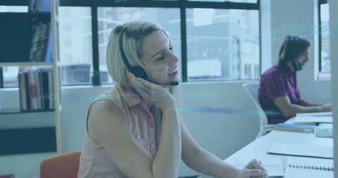 Office Workers Analyzing Digital Data in Modern Workspace