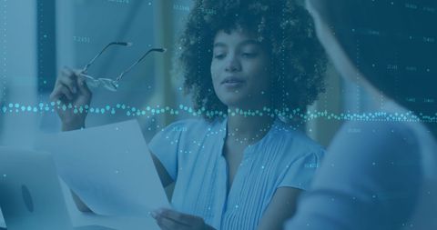 Discussing Financial Data in Modern Office Setting