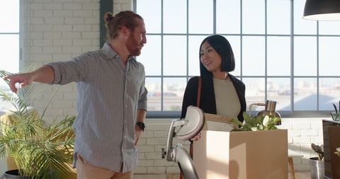 Diverse colleagues collaborating and organizing new office space