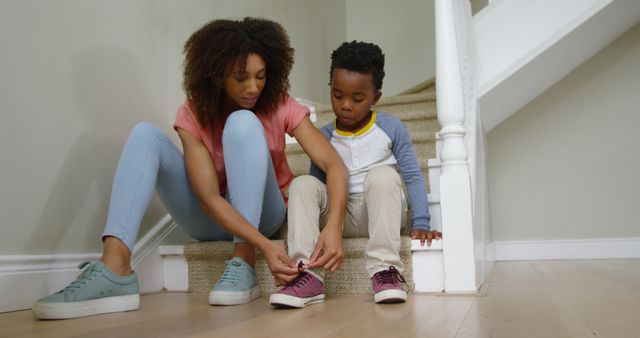 Mother Tying Child's Sneaker on Stairs at Home - Download Free Stock Images Pikwizard.com