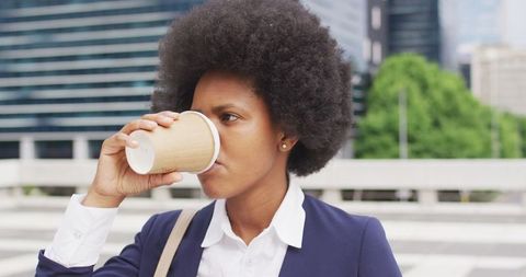 Businesswoman Enjoying Coffee Outside in Urban Settings