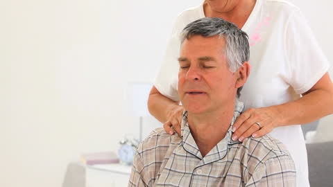 Senior Couple Enjoying a Relaxing Neck Massage at Home