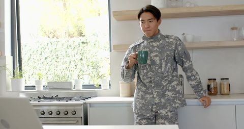 Asian Male Soldier Relaxing at Home with Coffee