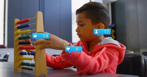 Boy counting with wooden abacus conveys edtech and learning concepts
