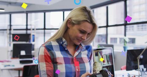 Creative photographer adjusting camera in modern office environment