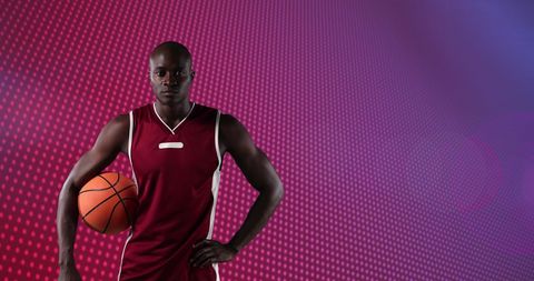 African American Basketball Player Holding Ball with Dynamic Background