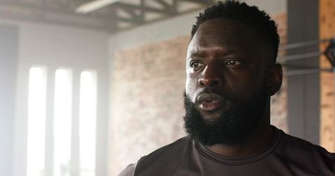 Focused African American Male Athlete Training in Urban Gym Environment