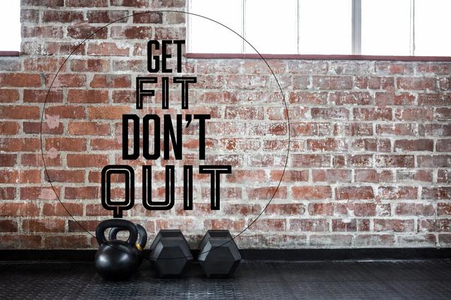 Motivational fitness message displayed on a brick wall in a gym setting. Kettlebell and dumbbells are placed on the floor, emphasizing strength and training. Ideal for use in fitness blogs, gym advertisements, social media posts, and health-related promotional materials.