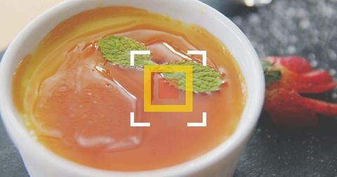 Elegant presentation of orange custard with fresh mint garnish