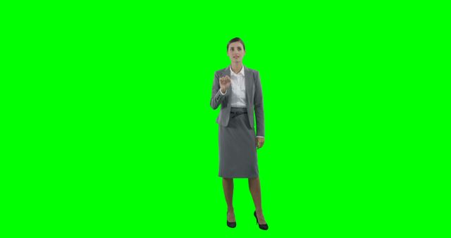 Businesswoman in Gray Suit Making Pointing Gesture on Green Screen - Download Free Stock Images Pikwizard.com