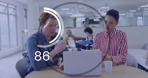 Coworkers collaborating at laptop with futuristic hud progress ring showing 86 percent