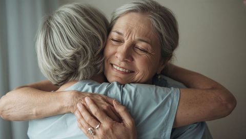 Senior women embracing, sharing tender smile and lifelong bond of affection